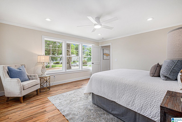 bedroom with hardwood / wood-style flooring, ceiling fan, and crown molding