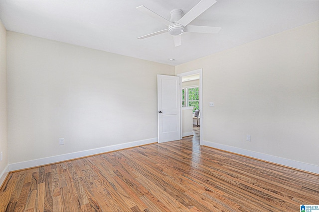 unfurnished room with hardwood / wood-style floors and ceiling fan