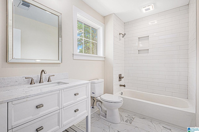 full bathroom with vanity, toilet, and tiled shower / bath