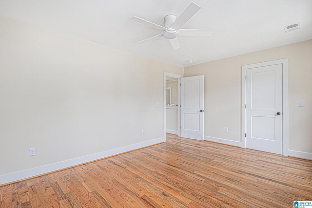 empty room featuring light wood-type flooring and ceiling fan