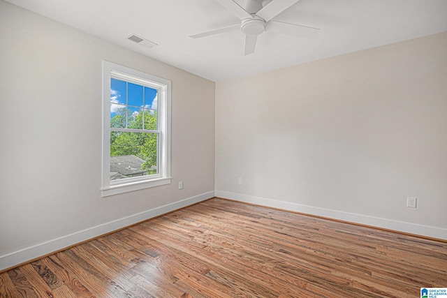 spare room with hardwood / wood-style flooring and ceiling fan