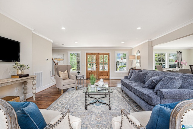 living room featuring hardwood / wood-style floors, french doors, and crown molding