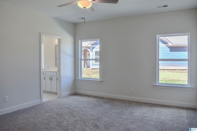 carpeted spare room featuring ceiling fan