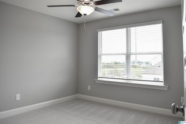 spare room with carpet and ceiling fan