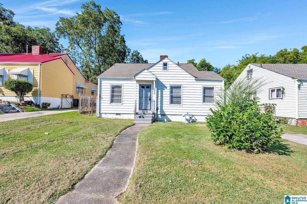 bungalow-style house with a front lawn