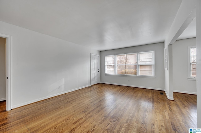 empty room with hardwood / wood-style floors