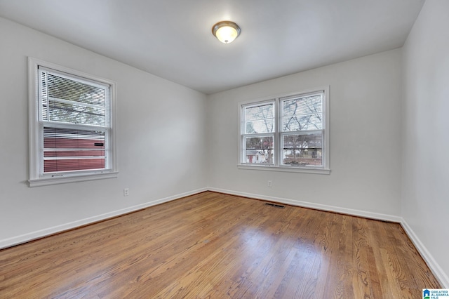 spare room featuring light hardwood / wood-style floors