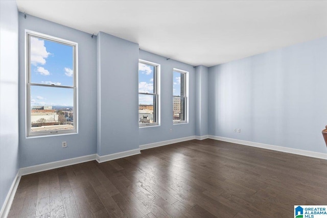 spare room with dark hardwood / wood-style floors