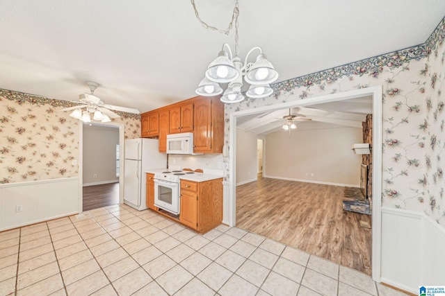 kitchen featuring ceiling fan with notable chandelier, white appliances, and light tile patterned floors