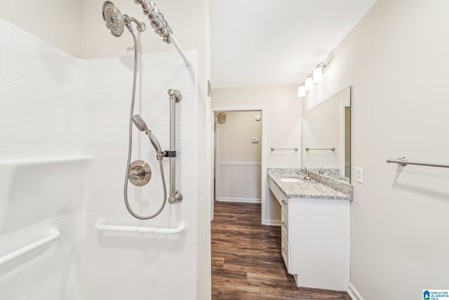 bathroom featuring a shower, vanity, and wood-type flooring