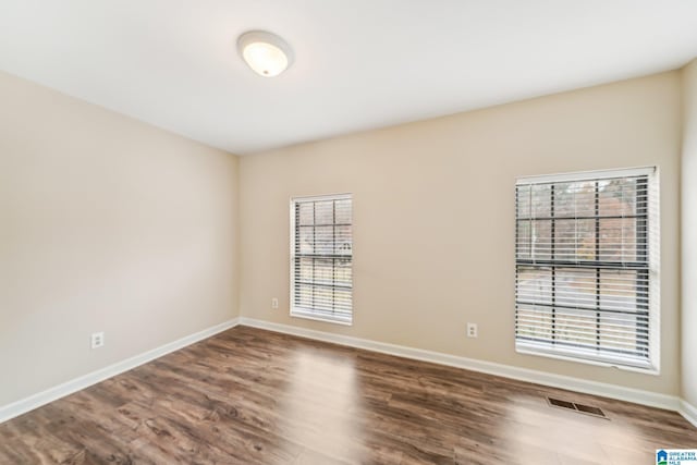 unfurnished room featuring hardwood / wood-style floors and a healthy amount of sunlight