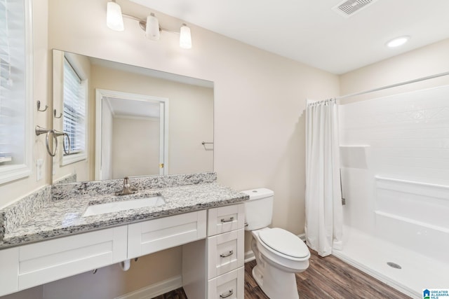 bathroom featuring a shower with curtain, vanity, wood-type flooring, and toilet