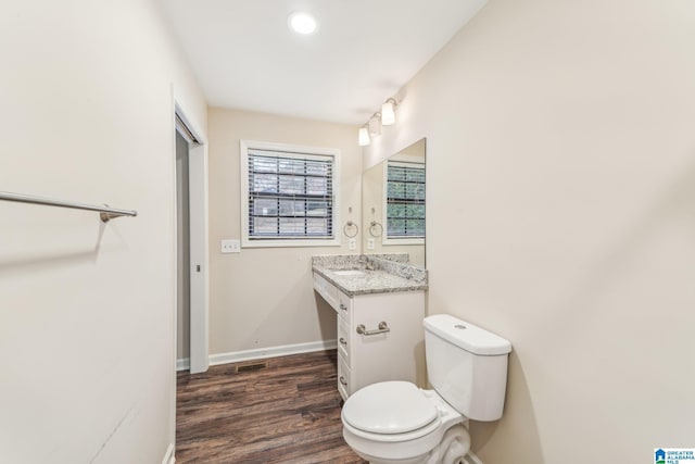 bathroom featuring vanity, hardwood / wood-style flooring, and toilet