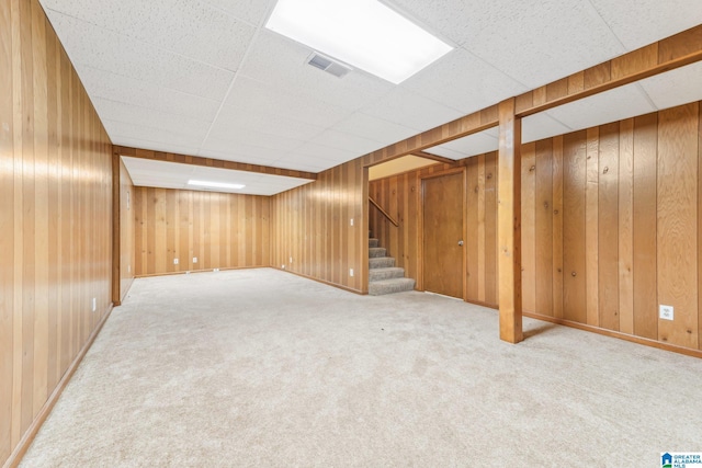 basement with wooden walls and carpet floors