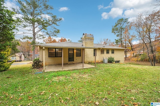 rear view of house featuring a yard and a patio