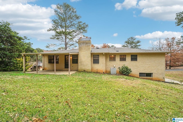 rear view of property with a patio area, a yard, and central air condition unit