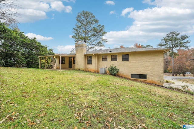 back of house featuring a yard and cooling unit