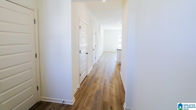 hall with hardwood / wood-style floors