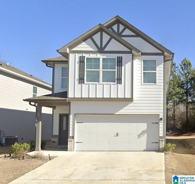 view of front of home with a garage and central air condition unit