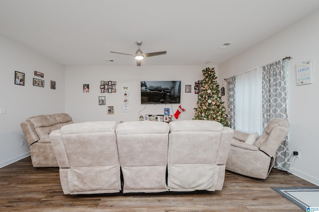 living room with hardwood / wood-style flooring and ceiling fan