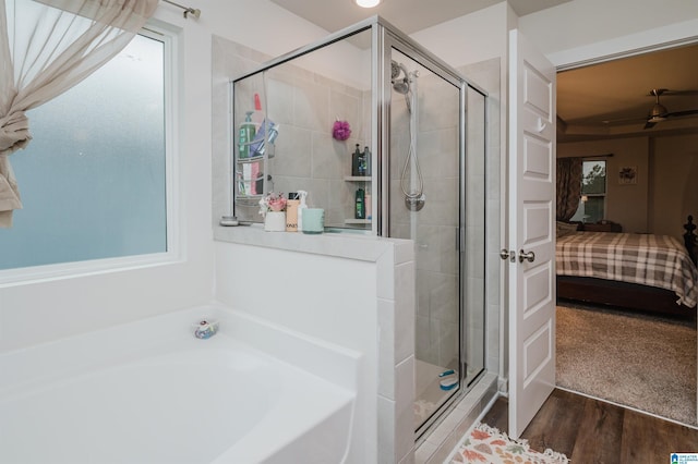 bathroom with separate shower and tub, ceiling fan, and wood-type flooring