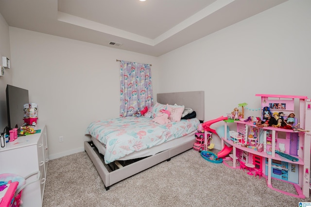 carpeted bedroom featuring a tray ceiling