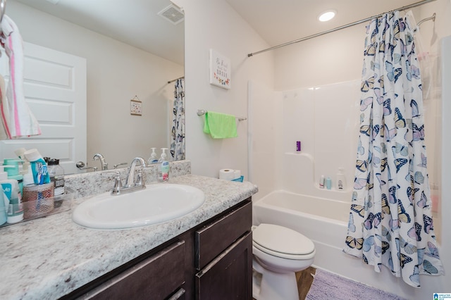 full bathroom featuring vanity, toilet, and shower / bath combo with shower curtain