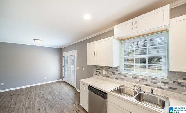 kitchen featuring dishwasher, white cabinets, and sink