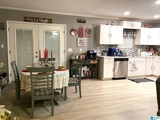 kitchen with tasteful backsplash, white cabinetry, dishwasher, and light hardwood / wood-style floors