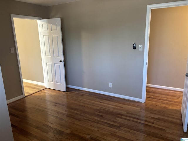 unfurnished room featuring dark wood-type flooring