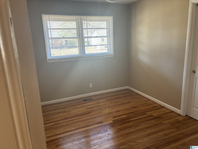 empty room with dark wood-type flooring