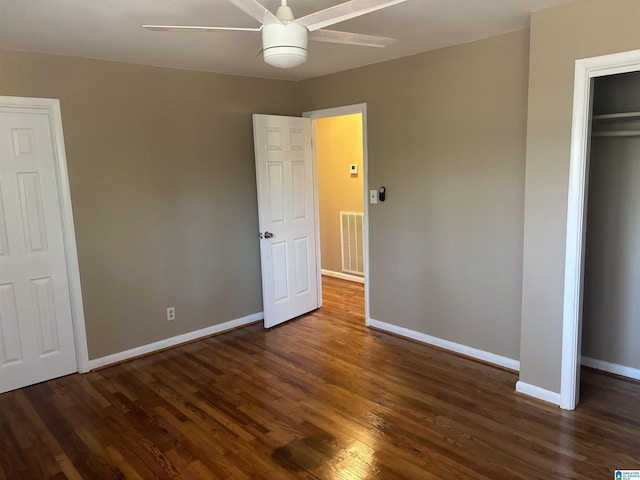 unfurnished bedroom featuring a closet, dark hardwood / wood-style floors, and ceiling fan