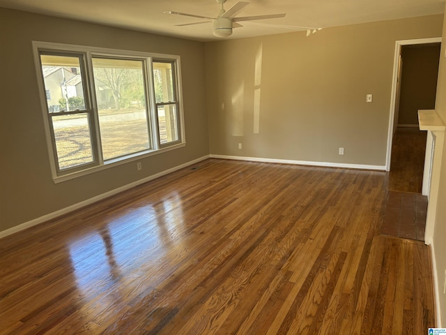 unfurnished room featuring ceiling fan and dark hardwood / wood-style floors