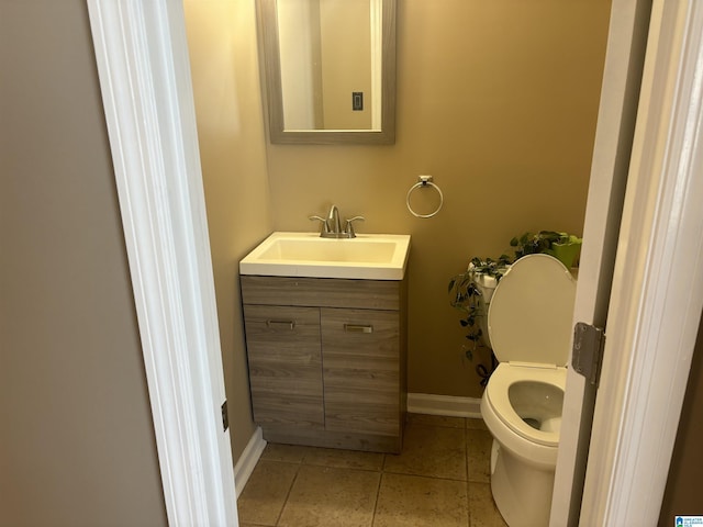 bathroom with tile patterned flooring, vanity, and toilet