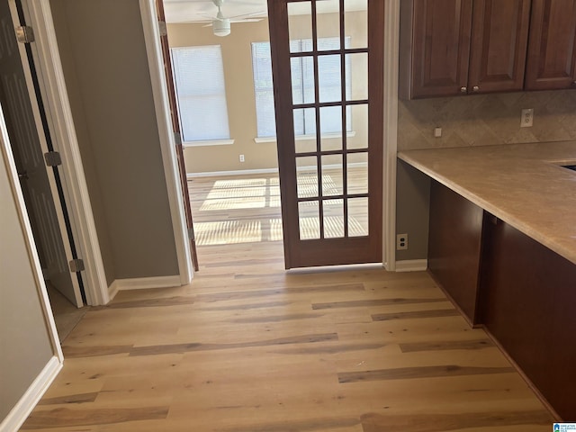 interior space with a wealth of natural light, light hardwood / wood-style flooring, and ceiling fan