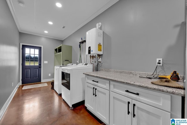 washroom featuring washer and dryer, crown molding, cabinets, and water heater