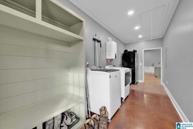 washroom with ornamental molding and washing machine and clothes dryer