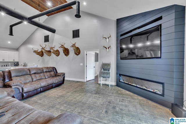 living room featuring wooden ceiling, a fireplace, and high vaulted ceiling