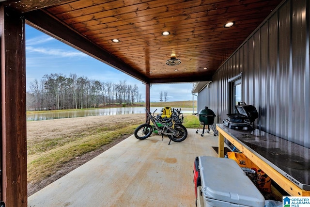 view of patio with a water view and a grill