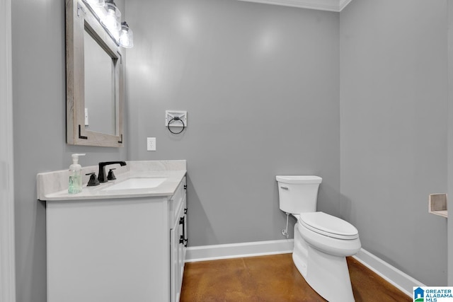 bathroom with vanity, toilet, and ornamental molding