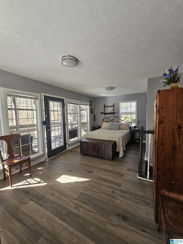 bedroom with dark wood-type flooring and a textured ceiling