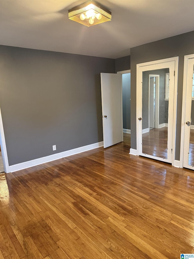 unfurnished room featuring hardwood / wood-style flooring