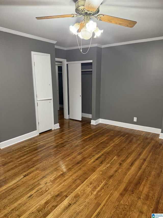 unfurnished bedroom featuring dark hardwood / wood-style floors, ceiling fan, and ornamental molding