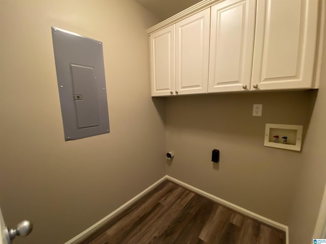 washroom with cabinets, electric panel, hookup for a washing machine, dark hardwood / wood-style floors, and hookup for an electric dryer