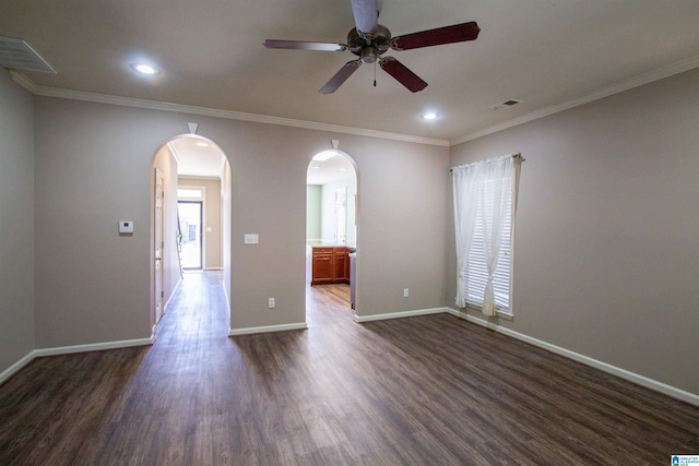 spare room with dark hardwood / wood-style flooring, ceiling fan, and crown molding