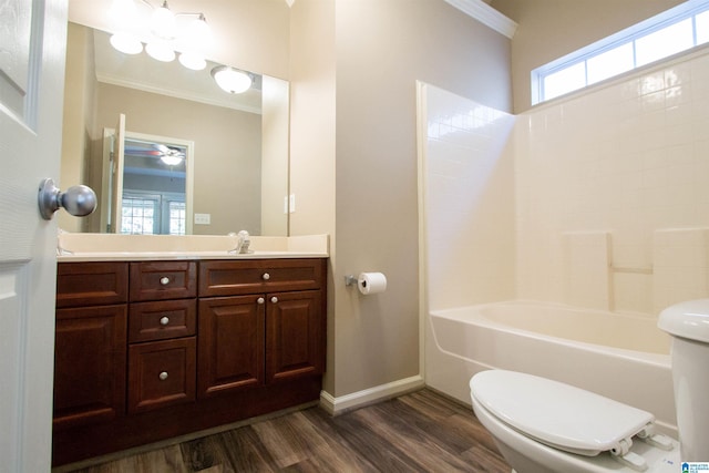 full bathroom with washtub / shower combination, crown molding, wood-type flooring, toilet, and vanity