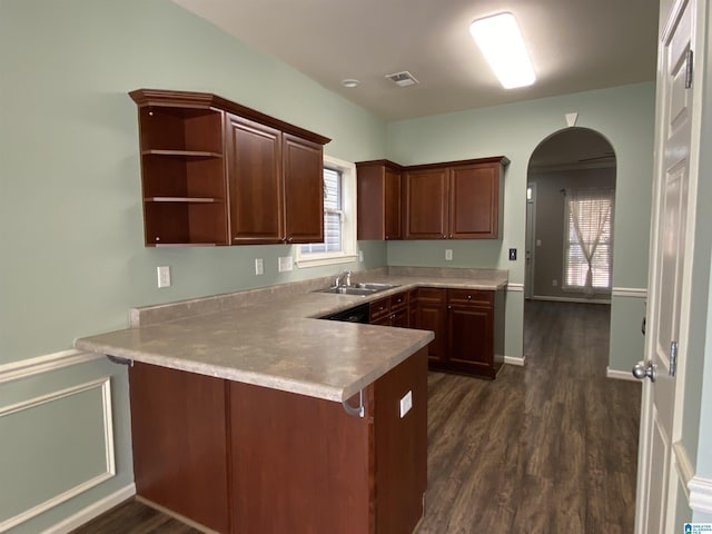 kitchen with kitchen peninsula, dark hardwood / wood-style floors, and sink