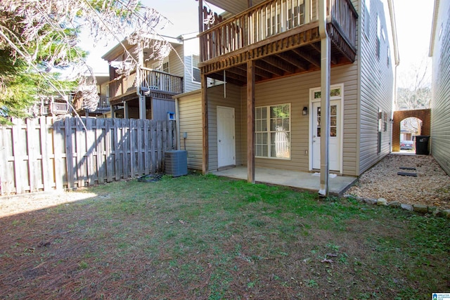 rear view of house featuring a patio area, a yard, and a deck