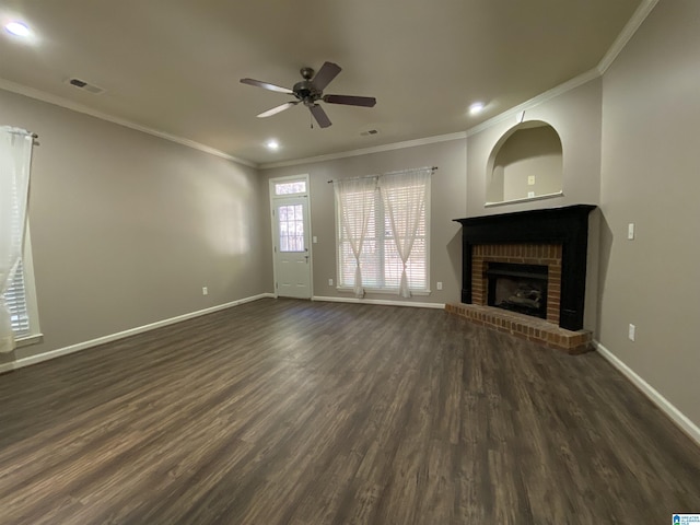 unfurnished living room with dark hardwood / wood-style flooring, a brick fireplace, ceiling fan, and ornamental molding