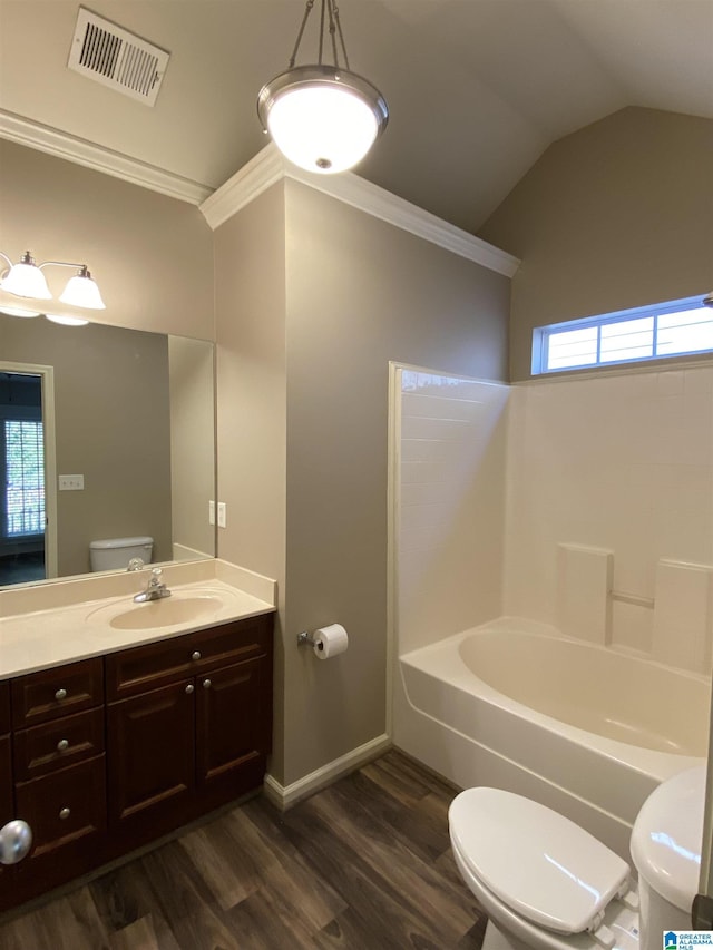 full bathroom with vanity, vaulted ceiling, shower / bathing tub combination, hardwood / wood-style floors, and toilet